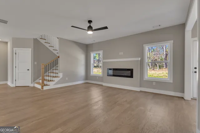 a kitchen with granite countertop white cabinets and a sink