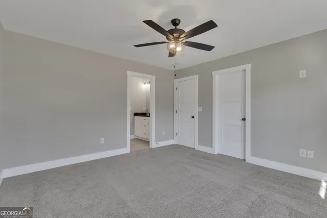 a view of a house with backyard and trees