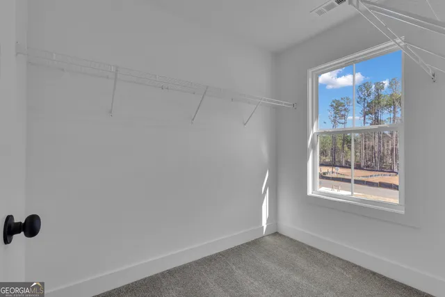 a view of a house with backyard and trees