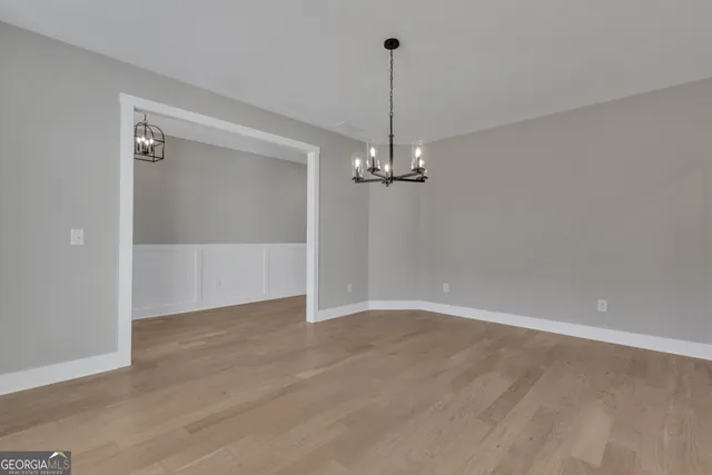 a kitchen with granite countertop white cabinets and sink