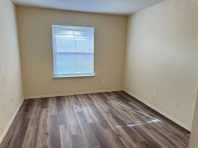 a view of a room with wooden floor