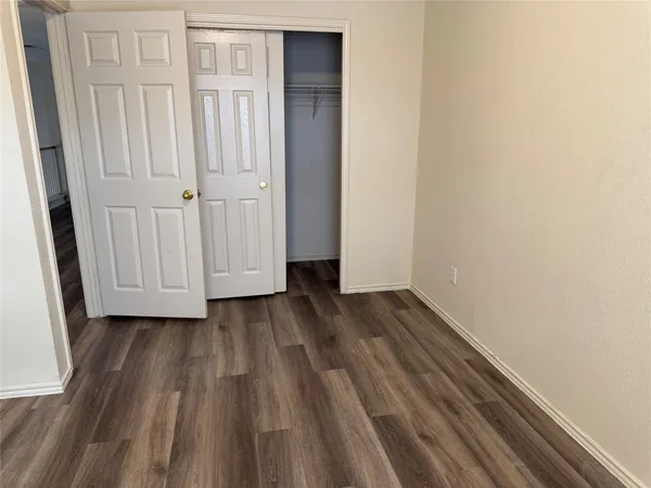a view of a room with wooden floor