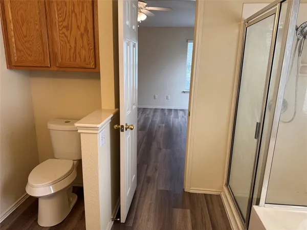 a bathroom with a toilet and a shower