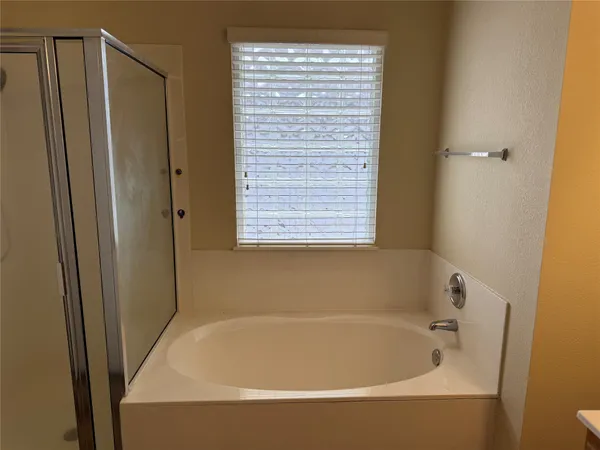 a white bath tub sitting next to a window