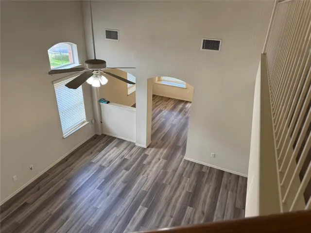 a view of a small space with wooden floor and a window