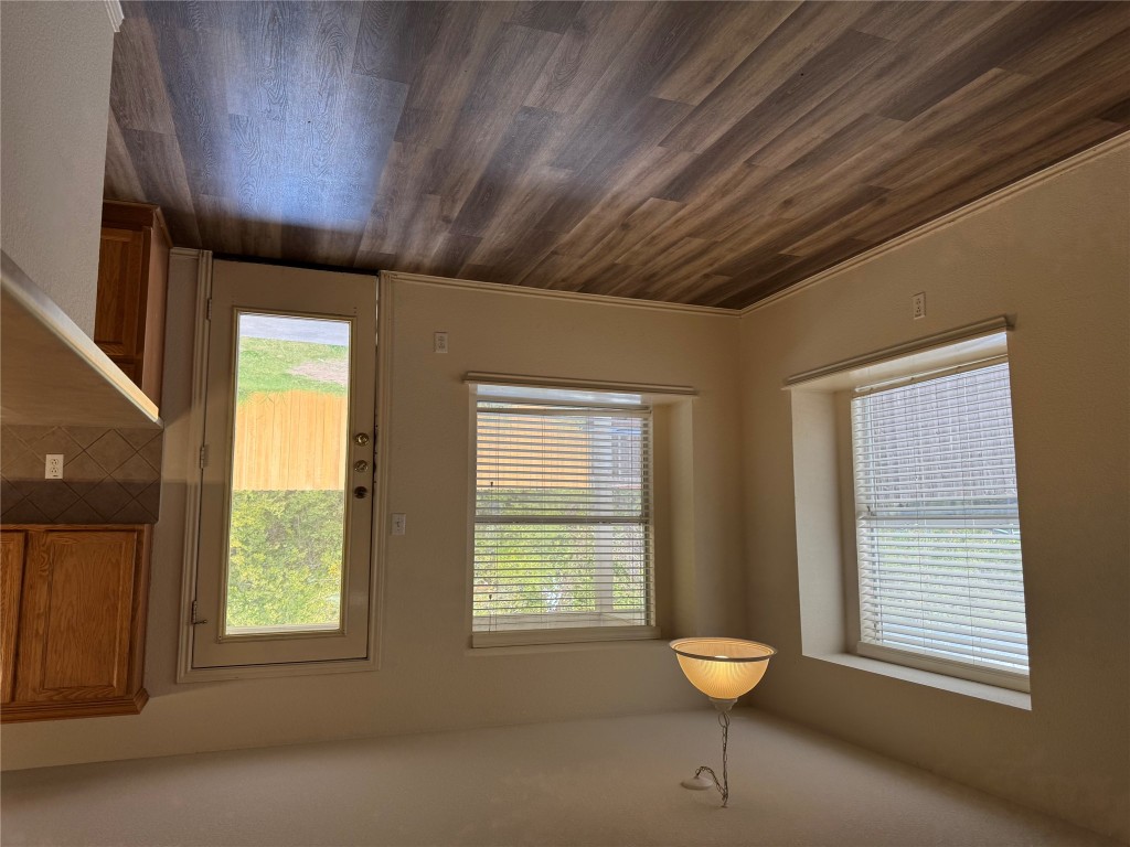 501 Grey Feather Court Round Rock, TX 78665 - Photo 4 of 28 a view of an empty room with wooden floor and a window