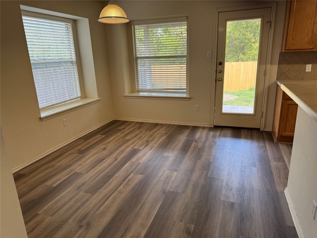 501 Grey Feather Court Round Rock, TX 78665 - Photo 5 of 28 a view of an empty room with wooden floor and a window