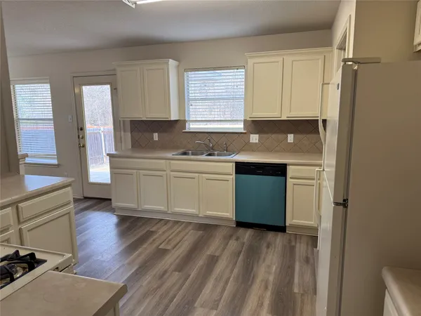 a kitchen with a sink stove and cabinets