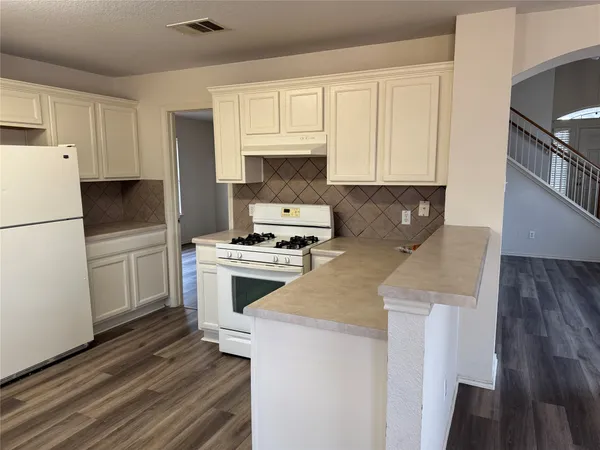 a kitchen with a white cabinets and white appliances