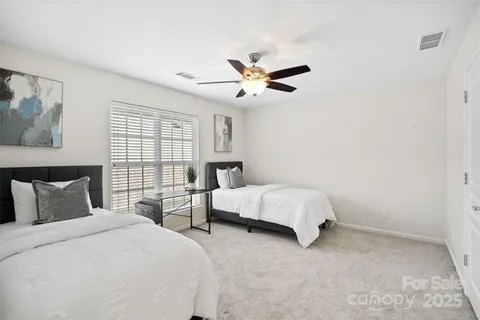 a bedroom with two beds and window