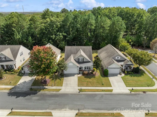 an aerial view of a house with a swimming pool