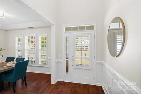 a view of a livingroom with furniture wooden floor and a window