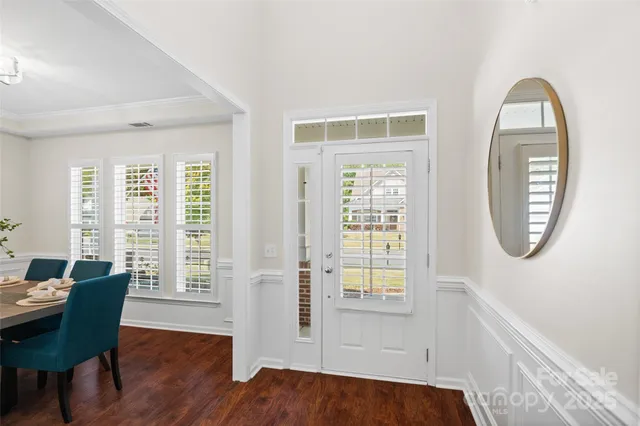 a view of a livingroom with furniture wooden floor and a window