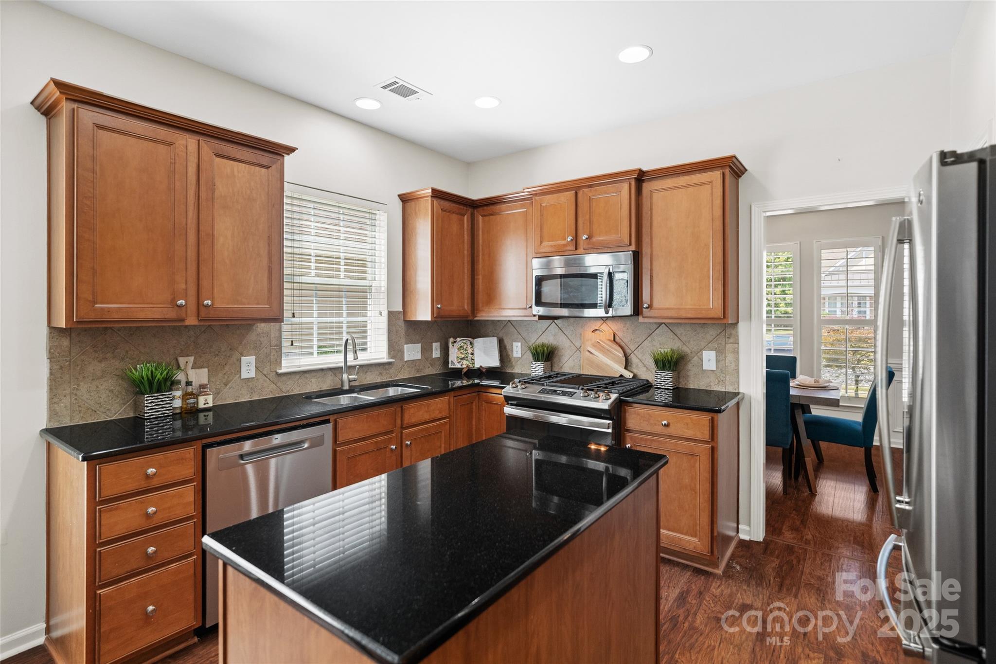 10471 Scotland Avenue Fort Mill, SC 29707 - Photo 4 of 20 a kitchen with stainless steel appliances granite countertop a sink a stove and a refrigerator