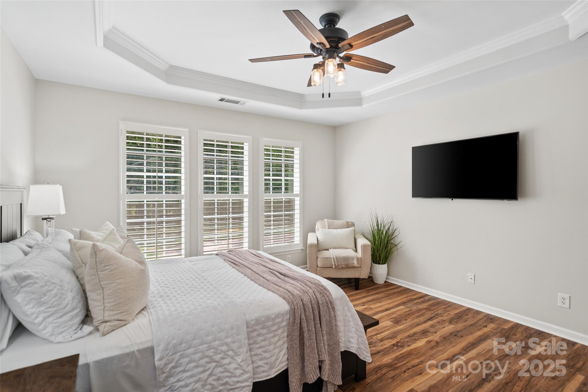10471 Scotland Avenue Fort Mill, SC 29707 - Photo 7 of 20 a bedroom with a bed a tv and wooden floor