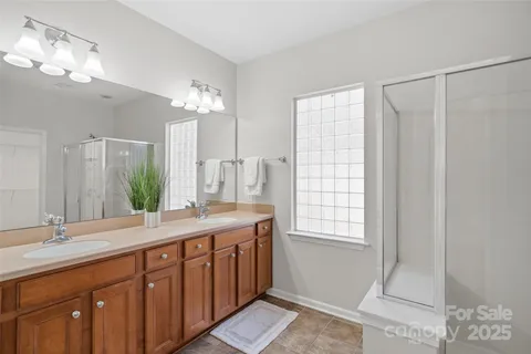 a bathroom with a double vanity sink and a mirror