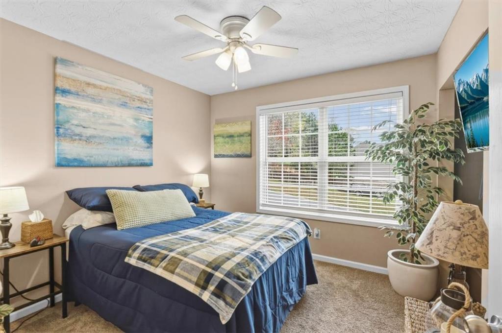 60 Sugar Birch Way Dallas, GA 30132 - Photo 12 of 31 a bedroom with a bed and a chandelier