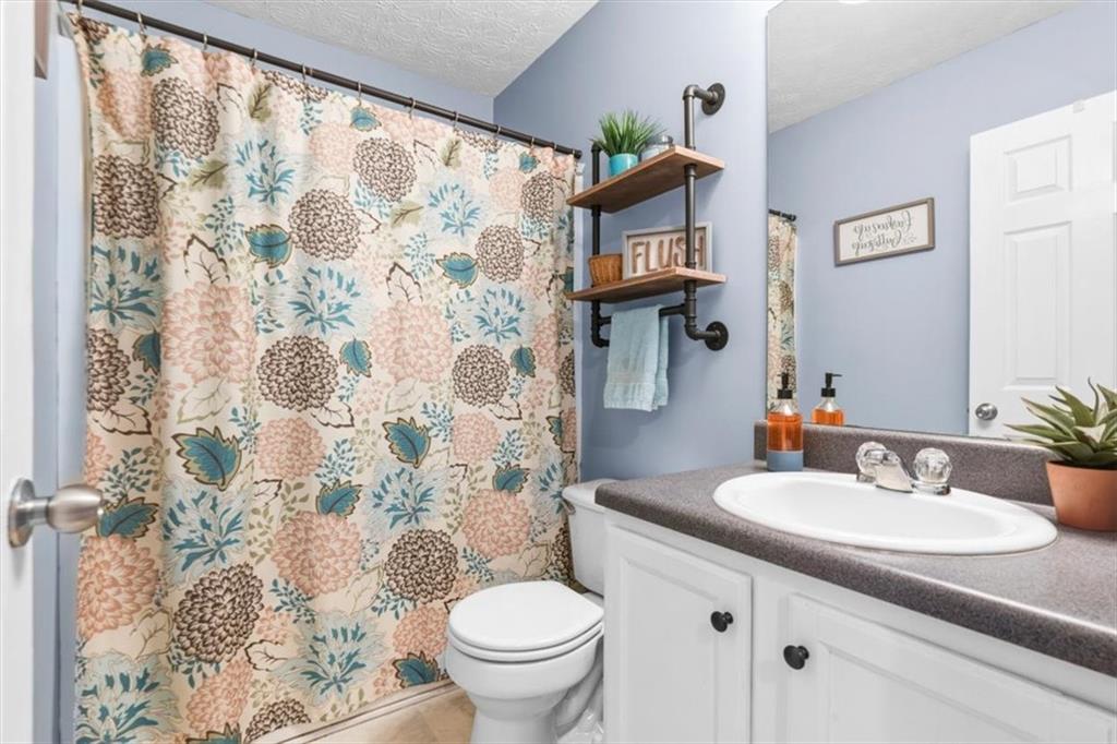 60 Sugar Birch Way Dallas, GA 30132 - Photo 13 of 31 a bathroom with a sink toilet and shower