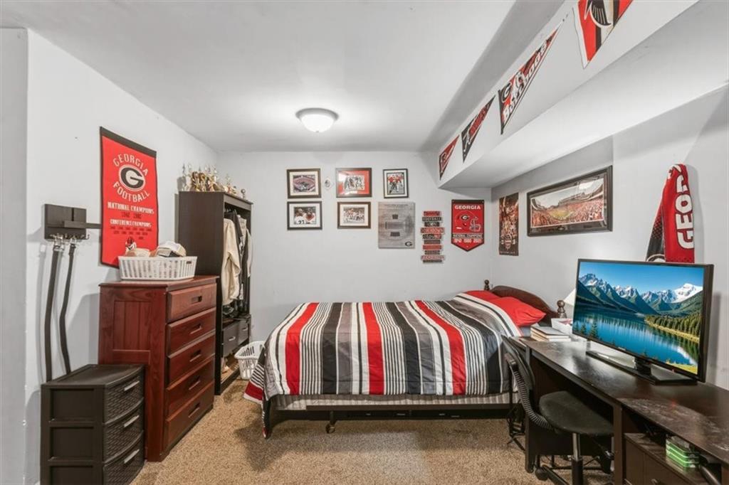 60 Sugar Birch Way Dallas, GA 30132 - Photo 17 of 31 a bedroom with a bed and a flat screen tv