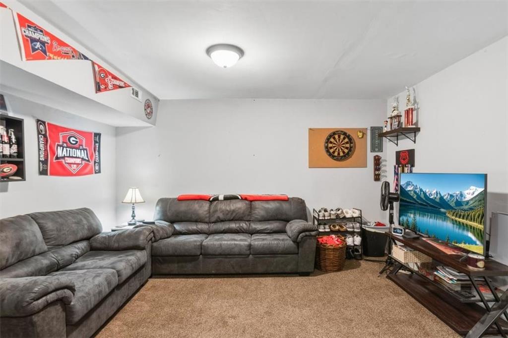 60 Sugar Birch Way Dallas, GA 30132 - Photo 18 of 31 a living room with furniture and a flat screen tv