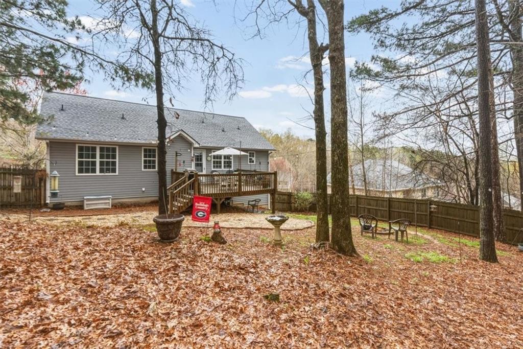 60 Sugar Birch Way Dallas, GA 30132 - Photo 22 of 31 a backyard of a house with barbeque oven table and chairs