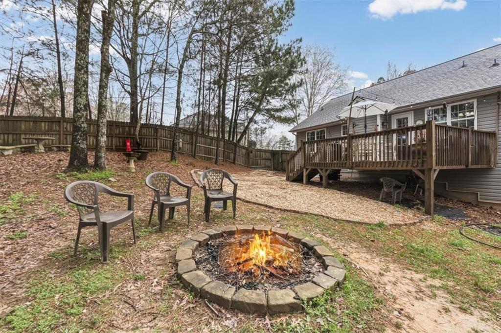 60 Sugar Birch Way Dallas, GA 30132 - Photo 26 of 31 a backyard of a house with barbeque oven table and chairs