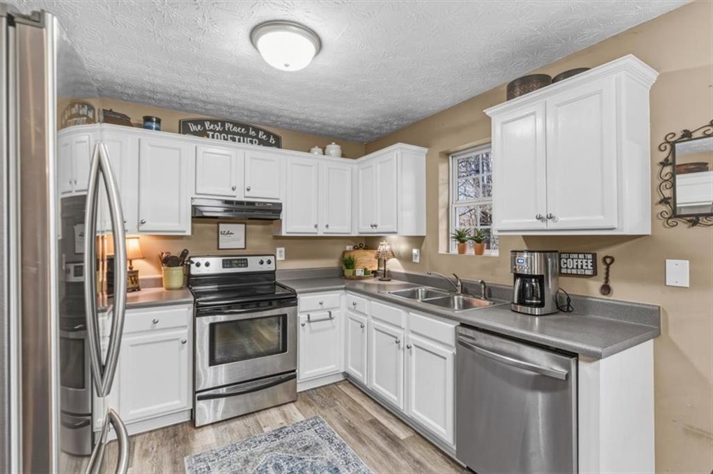 60 Sugar Birch Way Dallas, GA 30132 - Photo 4 of 31 a kitchen with white cabinets stainless steel appliances and sink