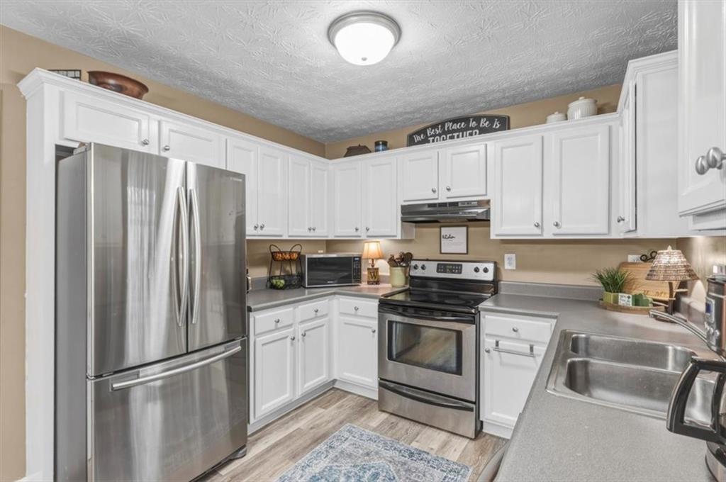60 Sugar Birch Way Dallas, GA 30132 - Photo 5 of 31 a kitchen with cabinets stainless steel appliances and a counter space