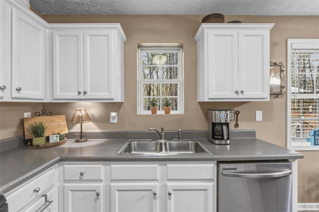 60 Sugar Birch Way Dallas, GA 30132 - Photo 6 of 31 a kitchen with stainless steel appliances granite countertop a sink a cabinets and window