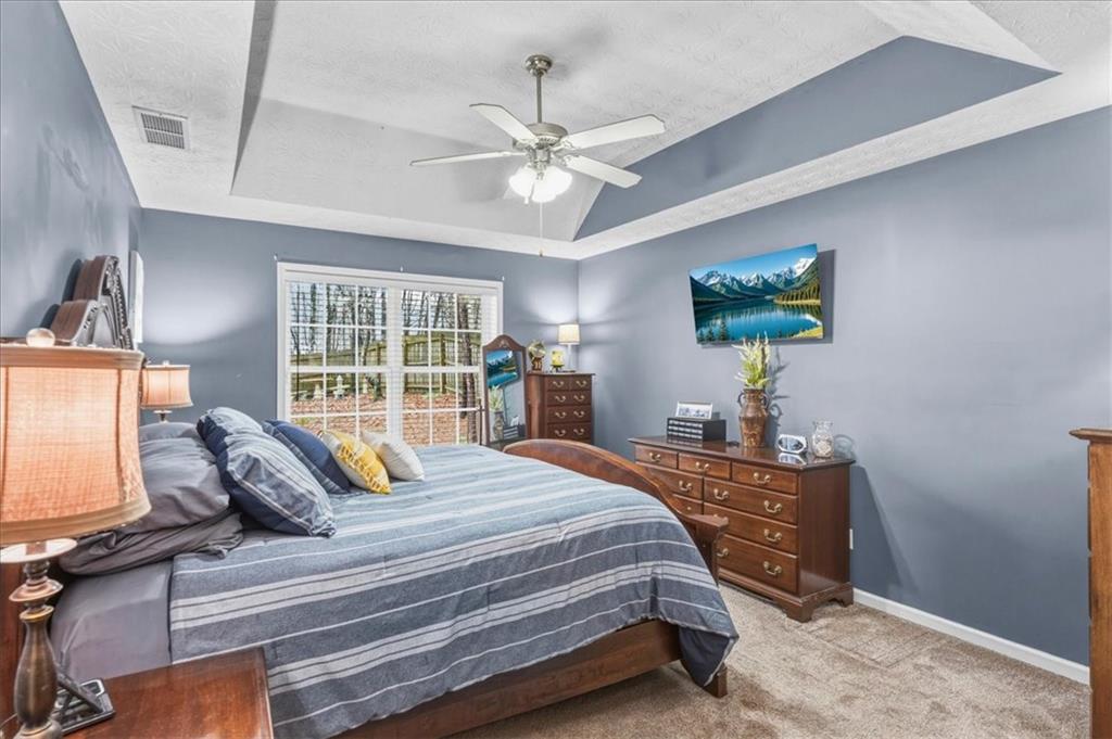 60 Sugar Birch Way Dallas, GA 30132 - Photo 8 of 31 a bedroom with a bed and glass windows