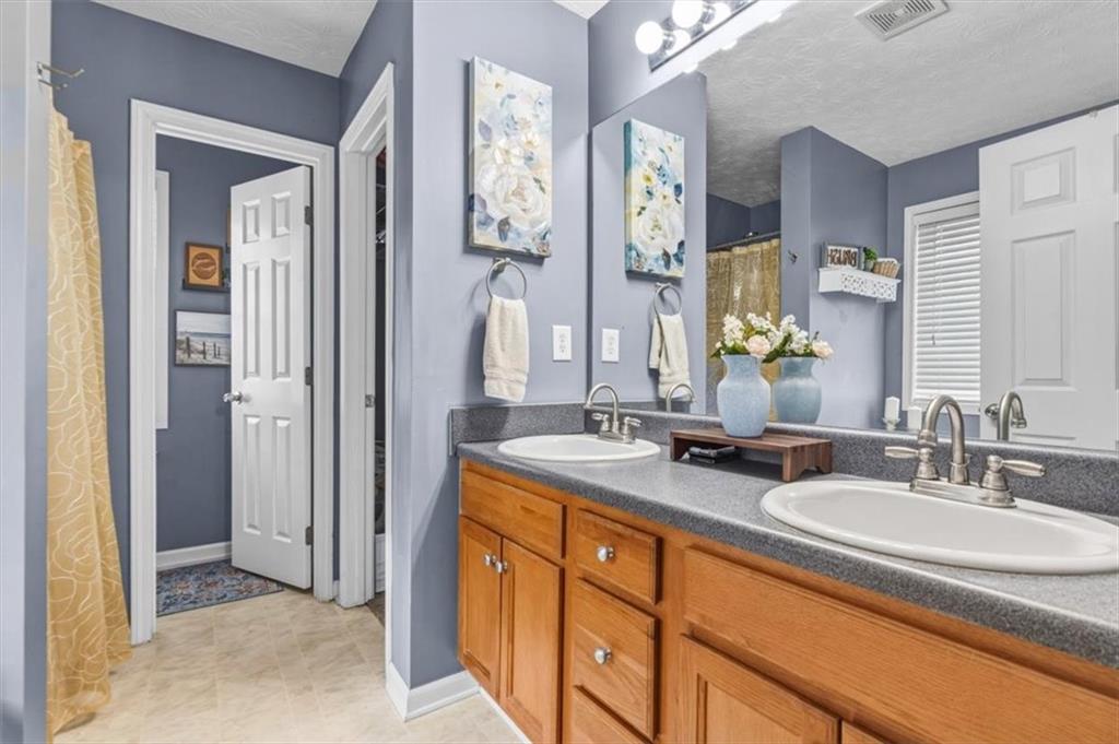 60 Sugar Birch Way Dallas, GA 30132 - Photo 10 of 31 a bathroom with a granite countertop sink and a mirror