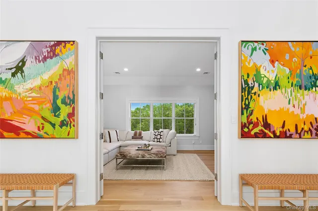 a living room with furniture and a painting on the wall
