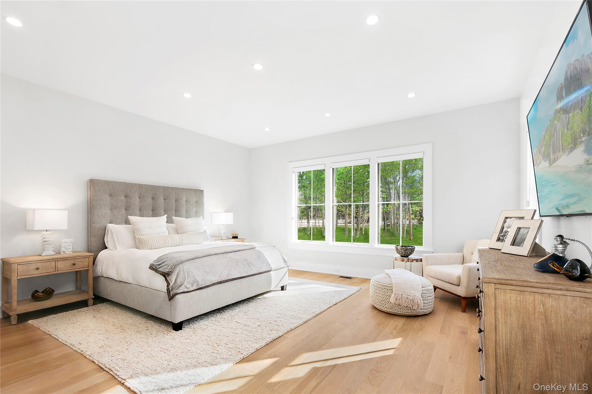 94 Merchants Path Sagaponack, NY 11962 - Photo 12 of 15 a spacious bedroom with a bed and a large window