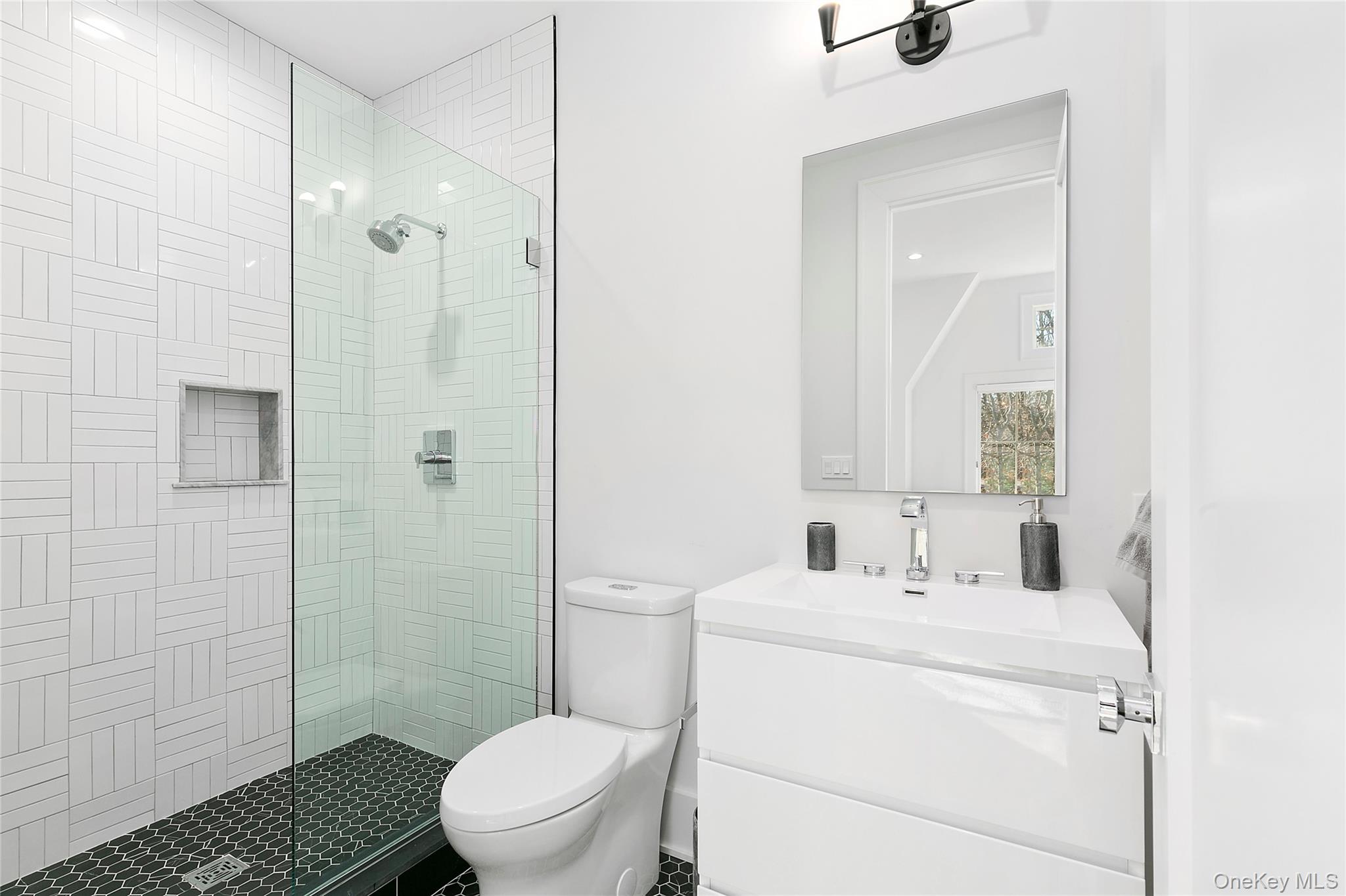 94 Merchants Path Sagaponack, NY 11962 - Photo 13 of 15 a bathroom with a sink toilet and shower