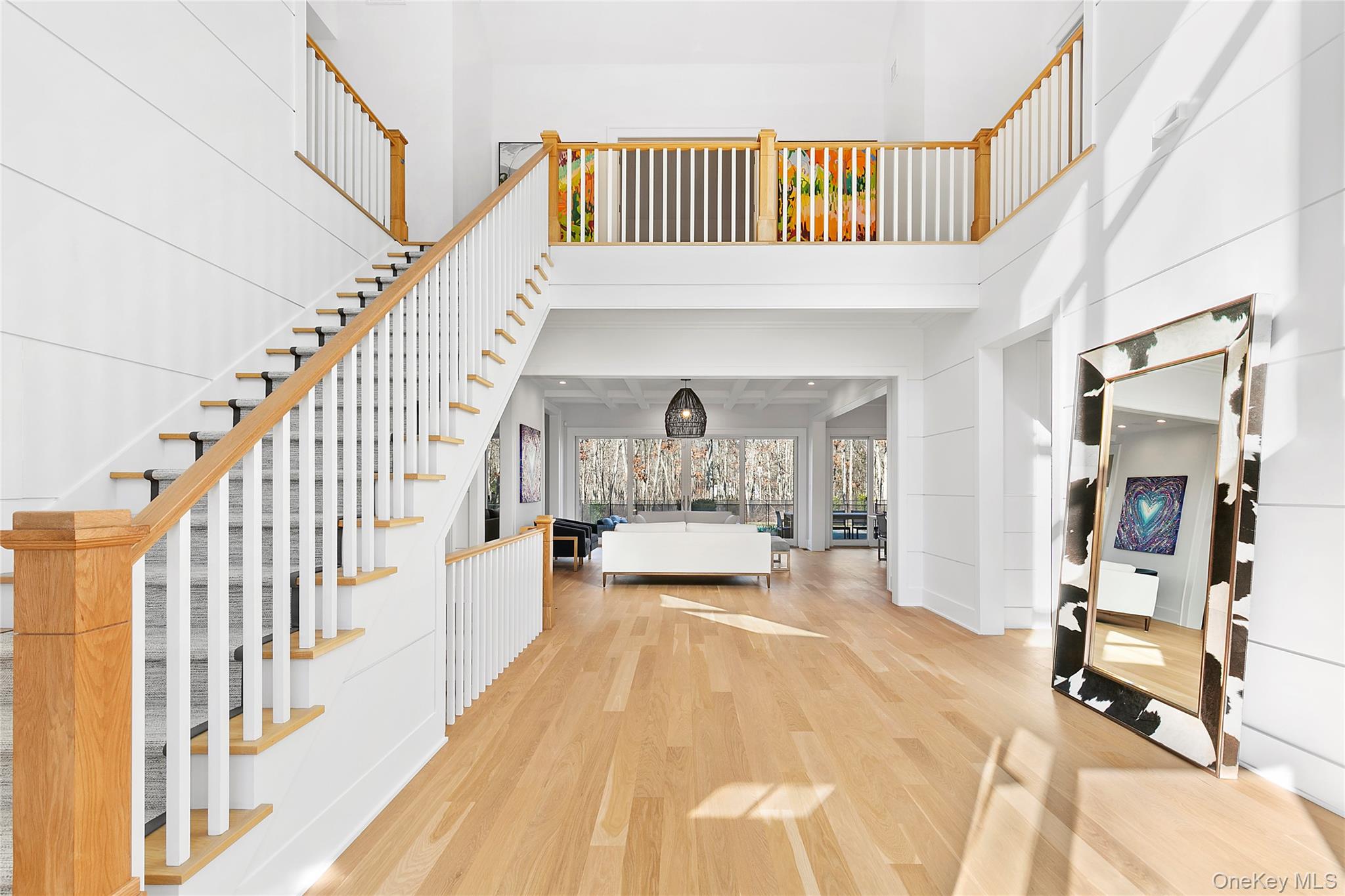 94 Merchants Path Sagaponack, NY 11962 - Photo 4 of 15 a view of a bedroom with wooden floor and staircase