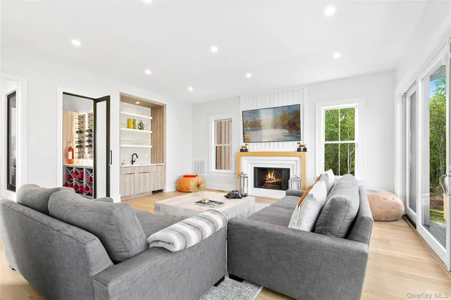 a living room with furniture a fireplace and a large window