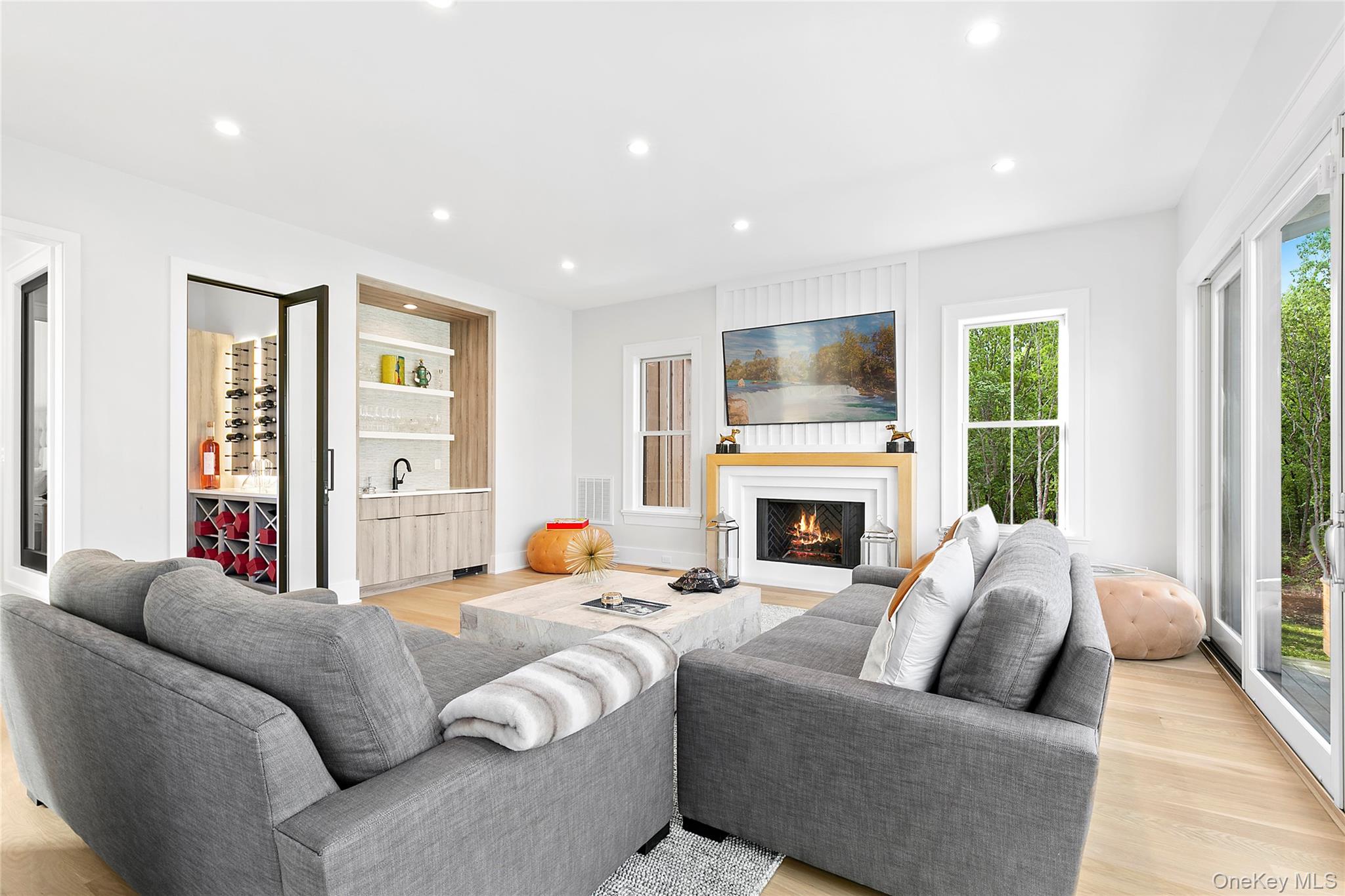 94 Merchants Path Sagaponack, NY 11962 - Photo 5 of 15 a living room with furniture a fireplace and a large window