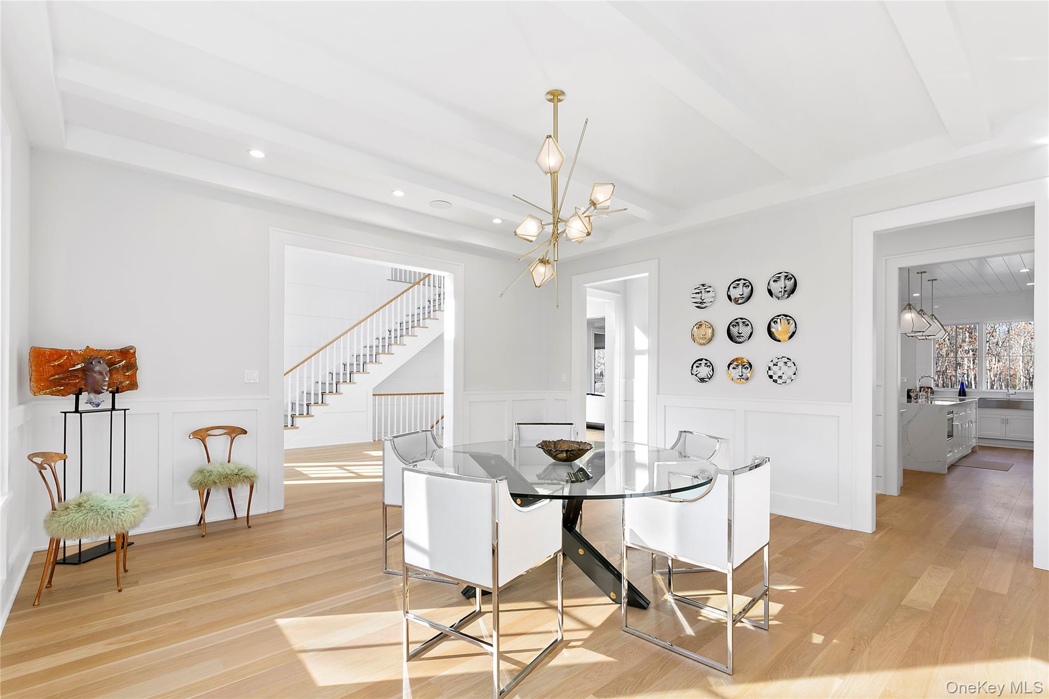 94 Merchants Path Sagaponack, NY 11962 - Photo 7 of 15 a dining room with wooden floor a chandelier a wooden table and chairs