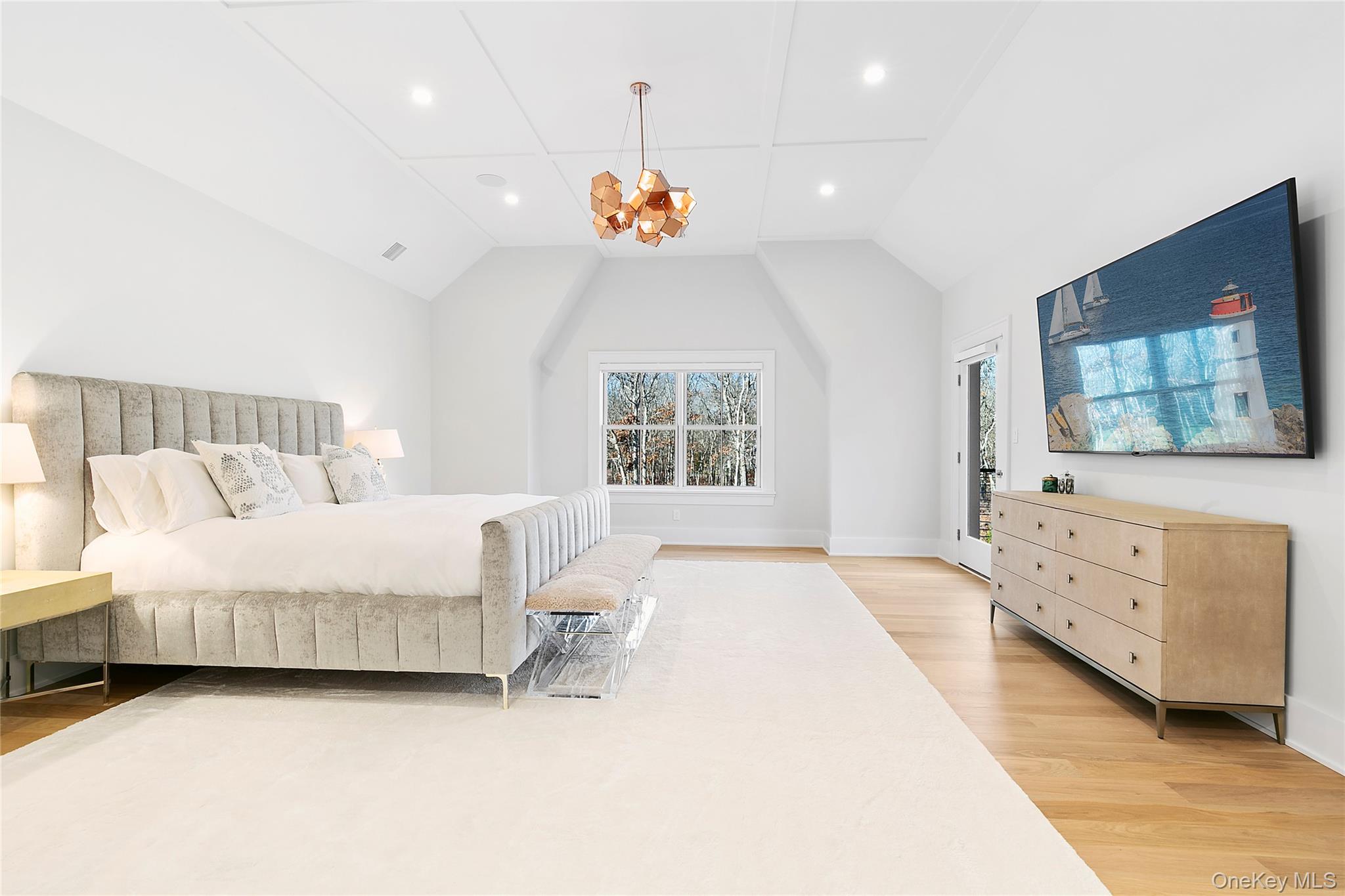 94 Merchants Path Sagaponack, NY 11962 - Photo 8 of 15 a bedroom with a bed a flat screen tv and a dresser
