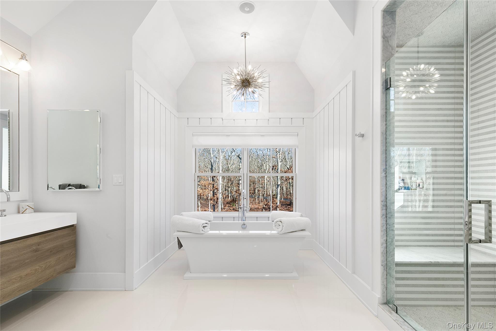 94 Merchants Path Sagaponack, NY 11962 - Photo 9 of 15 a spacious en suite bathroom with a tub double sink and mirror