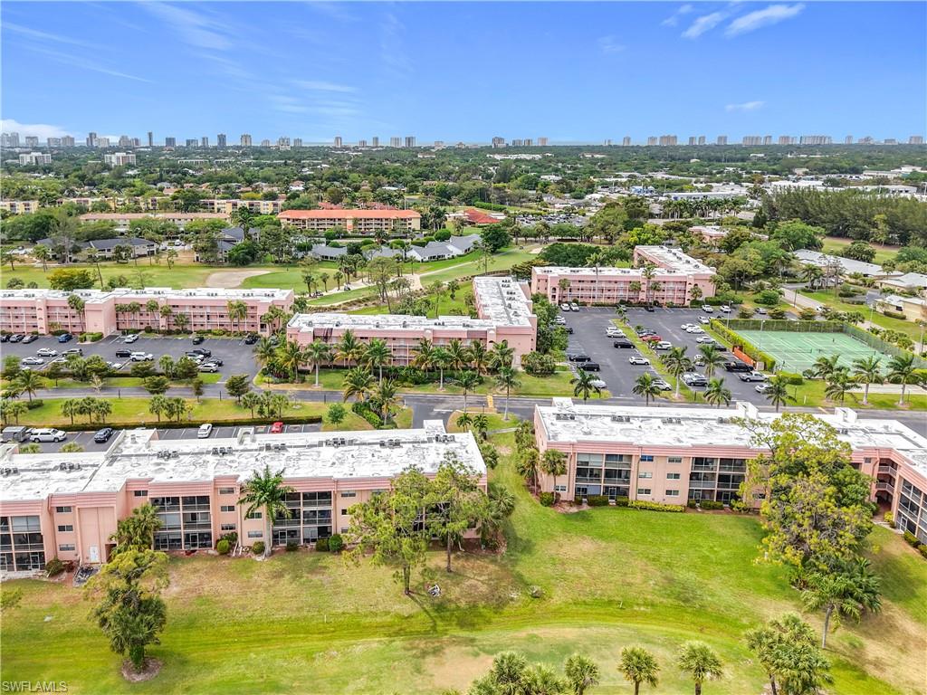 150 Turtle Lake Court, Unit 309 Naples, FL 34105 - Photo 2 of 42 Drone / aerial view of a skyline view and apartment complex / building