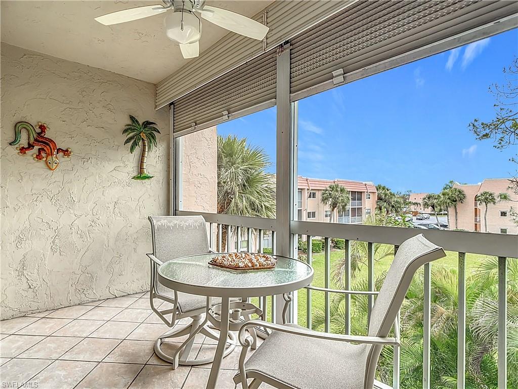 150 Turtle Lake Court, Unit 309 Naples, FL 34105 - Photo 29 of 42 Balcony featuring ceiling fan and a residential view