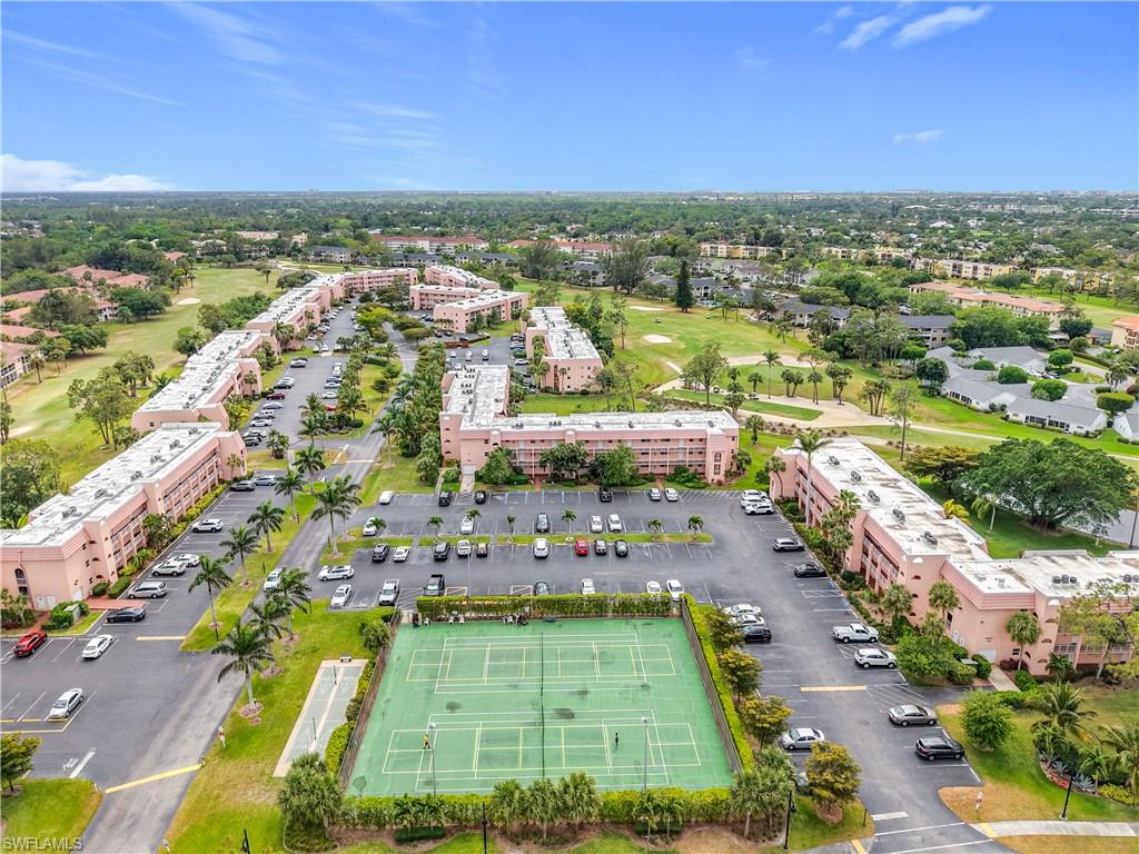 150 Turtle Lake Court, Unit 309 Naples, FL 34105 - Photo 4 of 42 Drone / aerial view of apartment complex / building and a golf club