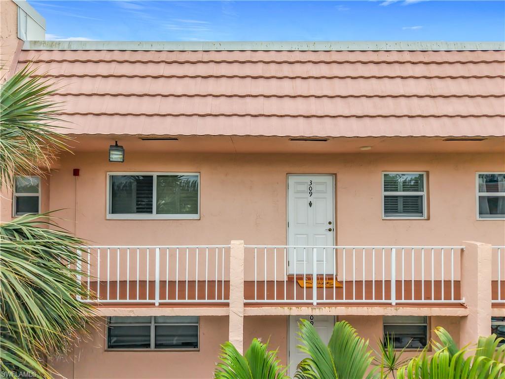 150 Turtle Lake Court, Unit 309 Naples, FL 34105 - Photo 9 of 42 View of front of property with stucco siding and a tile roof
