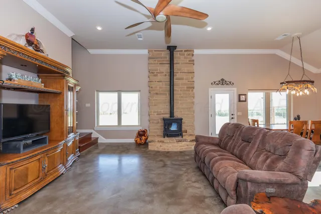 a bedroom with a bed a dresser and a flat screen tv