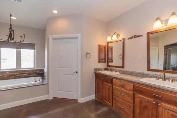 a view of a patio with chairs and floor to ceiling window next to a yard