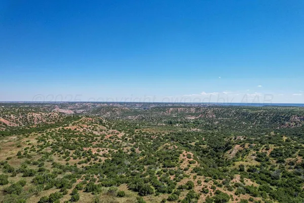 a living room with furniture ceiling fan and a large window