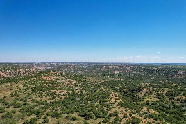 a living room with furniture ceiling fan and a large window