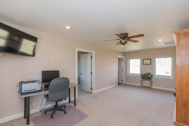 an aerial view of a house with a street
