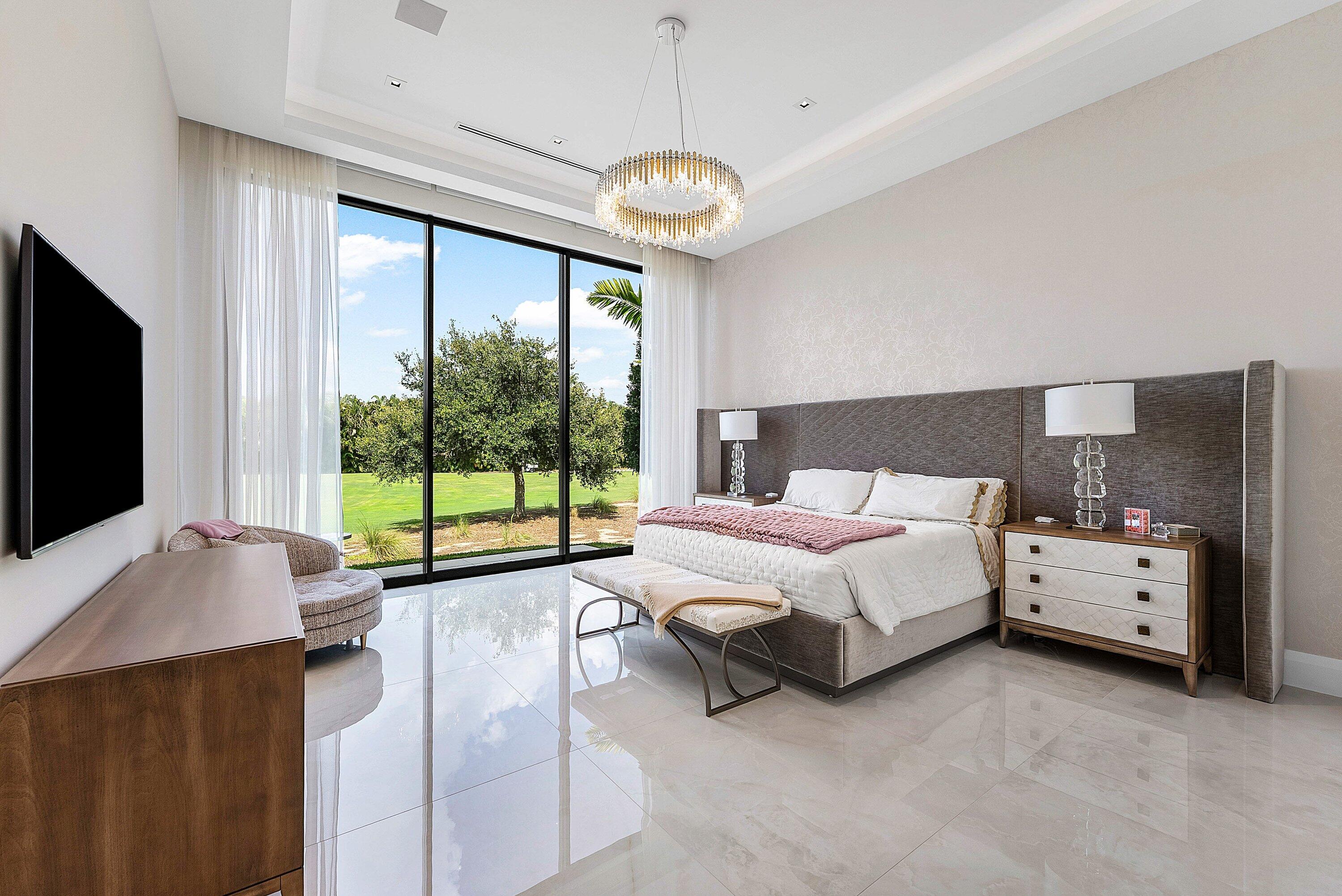 17615 Foxborough Lane Boca Raton, FL 33496 - Photo 30 of 120 a spacious bedroom with a bed and a flat tv screen on dresser